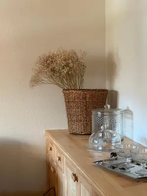 a counter with a vase of flowers on top of it at Luxury Chalet at the Foot of the Dolomites by the Castle in La Villa