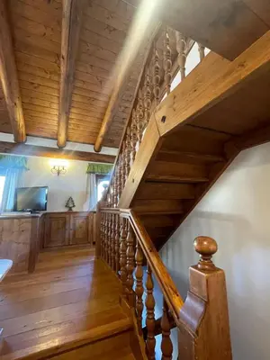 a staircase in a house with wooden ceilings at Chalet Alba in Cortina dʼAmpezzo