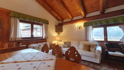 a living room with a couch and a table at Chalet Alba in Cortina dʼAmpezzo