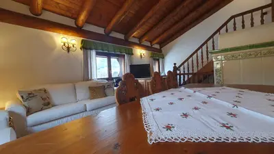 a living room with a bed and a couch at Chalet Alba in Cortina dʼAmpezzo