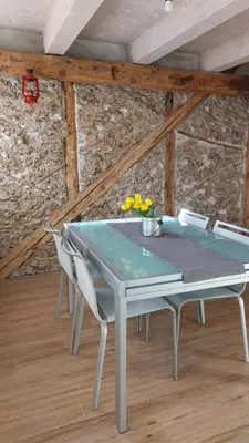 a ping pong table with two chairs in a room at Casa Mia in Agordo