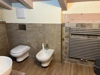 a bathroom with a toilet and a bidet at Casa Mia in Agordo
