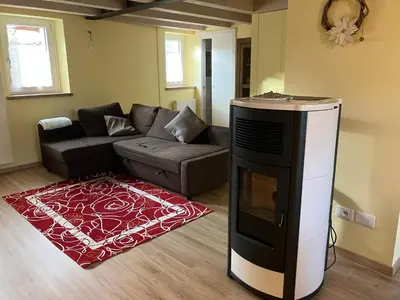 a living room with a couch and a tv at Casa Mia in Agordo