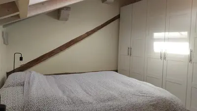 a bedroom with white cabinets and a bed at Casa Mia in Agordo