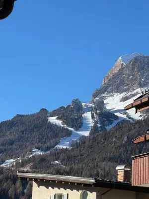 a view of a mountain with snow and a lake at Lisa & Fufi's Dolomites Home in Cortina dʼAmpezzo