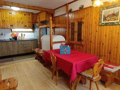a dining room with a table and a bunk bed at Lisa & Fufi's Dolomites Home in Cortina dʼAmpezzo