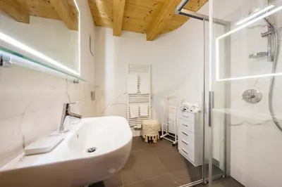 a bathroom with a sink and a shower at Chalet Lacedel - Dolomiti Skyline in Cortina dʼAmpezzo