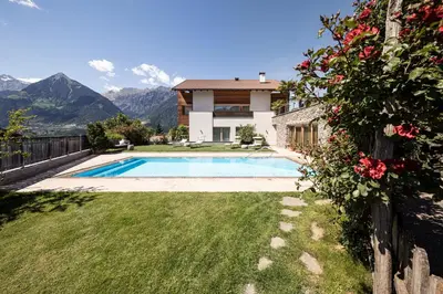 a house with a swimming pool in a yard at Torgglerhof in Schenna