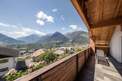 a balcony with a view of mountains at Torgglerhof in Schenna