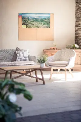a living room with two chairs and a table at Torgglerhof in Schenna