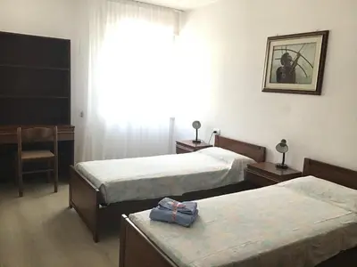 a hotel room with two beds and a window at Vacanza in relax in Mezzano