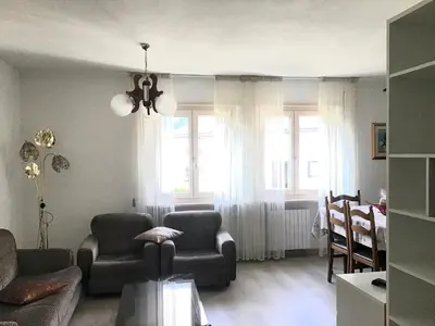 a living room with a couch and chairs and windows at Vacanza in relax in Mezzano