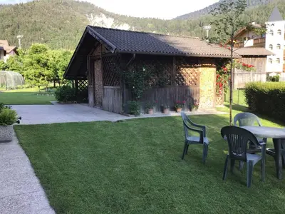 a patio with two chairs and a table in a yard at Vacanza in relax in Mezzano