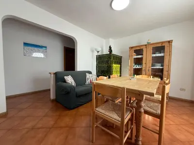 a hallway with a room with a shelf and a floor at Mountain Breeze in Castello di Fiemme