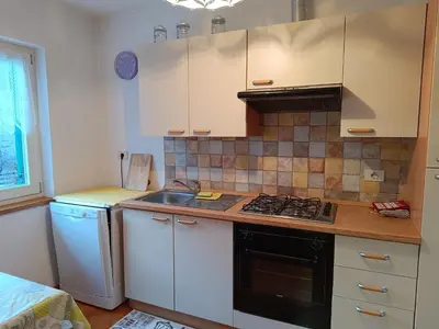 a kitchen with a sink and a stove at Mountain Breeze in Castello di Fiemme