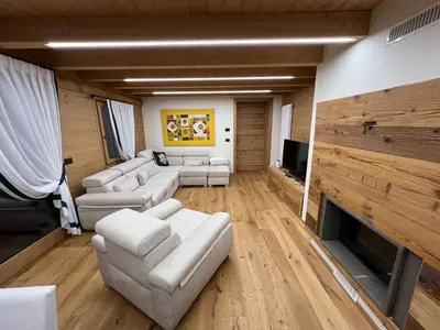a kitchen with a table and chairs in a room at Casa PAOLINA OLIMPIC 2026 in San Vito di Cadore