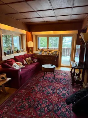 a living room with a couch and a table at Casa panoramica con terrazza vista Tofane in Cortina dʼAmpezzo
