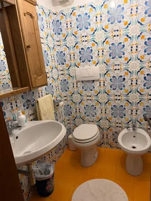a bathroom with a white toilet and a sink at Casa panoramica con terrazza vista Tofane in Cortina dʼAmpezzo