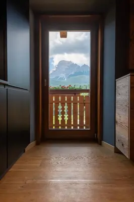 a kitchen door with a view of a mountain at Olympic Comfy Trimestate Ampezzo s Flat in San Vito di Cadore