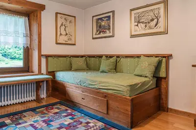 a bedroom with a window with teddy bears in it at Da La Auri in Canale dʼAgordo