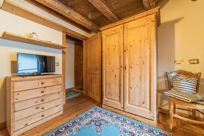 a living room with a couch and a tv at Da La Auri in Canale dʼAgordo