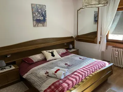 a bedroom with a bed with pillows on it at Ciasa Nonna Bon Bon in Cortina dʼAmpezzo
