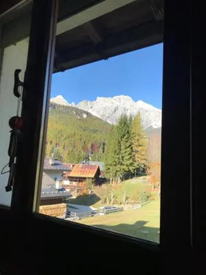 a view of a mountain from a window at Ciasa Nonna Bon Bon in Cortina dʼAmpezzo