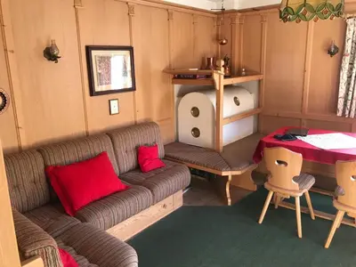 a living room with a couch and a table at Ciasa Nonna Bon Bon in Cortina dʼAmpezzo
