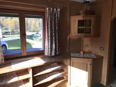 a kitchen with a large window in a room at Ciasa Nonna Bon Bon in Cortina dʼAmpezzo