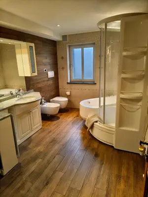 a bathroom with a tub and a toilet and a sink at 70 sqm apartment in Moena in Moena