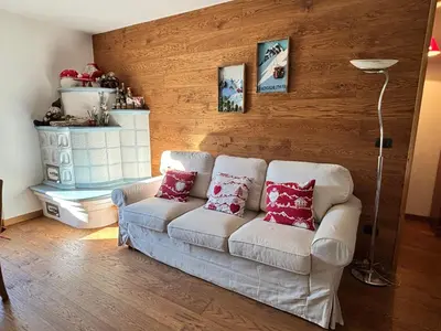 a living room with a white couch with red pillows at 70 sqm apartment in Moena in Moena