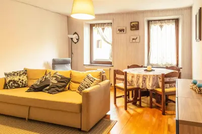 a living room with a couch and a table at Casa tipica nelle Dolomiti Trentine in Mezzano