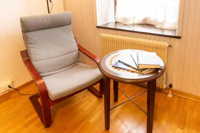 a table with a chair and a table with a tableablish at Casa tipica nelle Dolomiti Trentine in Mezzano