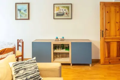 a blue cabinet in the corner of a living room at Casa tipica nelle Dolomiti Trentine in Mezzano