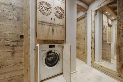 a washer and dryer in a room with wooden walls at Cortina Penthouse Attico Villa Diana in Pocol