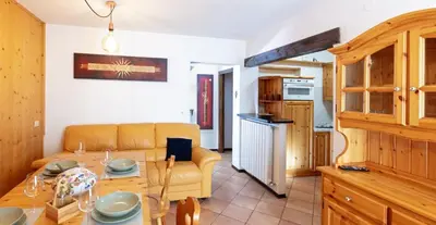 a living room with a couch and a table at HouSmart della Difesa 72 in San Vito di Cadore