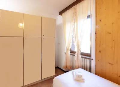 a kitchen with a white cabinet and a window at HouSmart della Difesa 72 in San Vito di Cadore