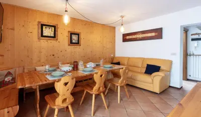 a living room with a wooden table and a couch at HouSmart della Difesa 72 in San Vito di Cadore
