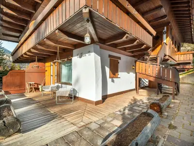 a dining room with a wooden table and chairs at Cianderies Cozy Apartment R&R in Cortina dʼAmpezzo