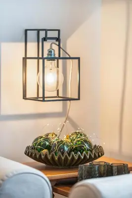 a chandelier hanging over a table next to a bowl at Cianderies Cozy Apartment R&R in Cortina dʼAmpezzo