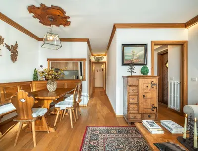 a living room with a couch and a table at Cianderies Cozy Apartment R&R in Cortina dʼAmpezzo