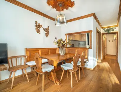 a bedroom with a large bed and a window at Cianderies Cozy Apartment R&R in Cortina dʼAmpezzo