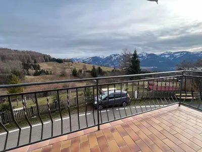 a car parked on a balcony with a view of mountains at Il sole di Varena in Varena