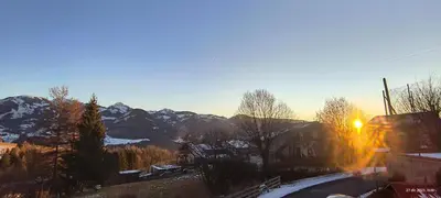 a sunset in the mountains with the sun going down at Il sole di Varena in Varena