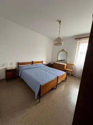 a bedroom with a bed and a dresser and a mirror at Il sole di Varena in Varena
