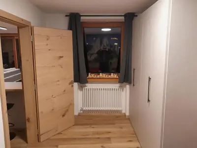 a room with a wooden door and a window at Casa Zena in Tesero