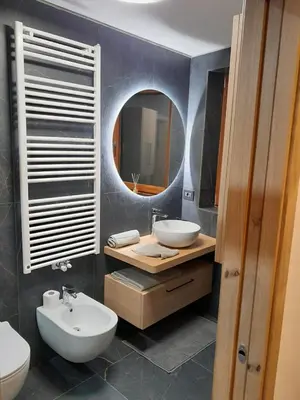 a bathroom with a sink and a mirror at Casa Zena in Tesero
