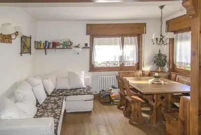 a living room with a couch and a table at Ca Tambres dimora nelle Dolomiti in San Vito di Cadore