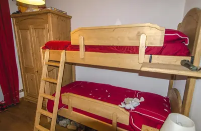 a couple of bunk beds in a room at Ca Tambres dimora nelle Dolomiti in San Vito di Cadore