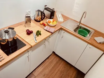 a kitchen with a wooden counter top and a sink at primiero-suite 45mq in Transacqua